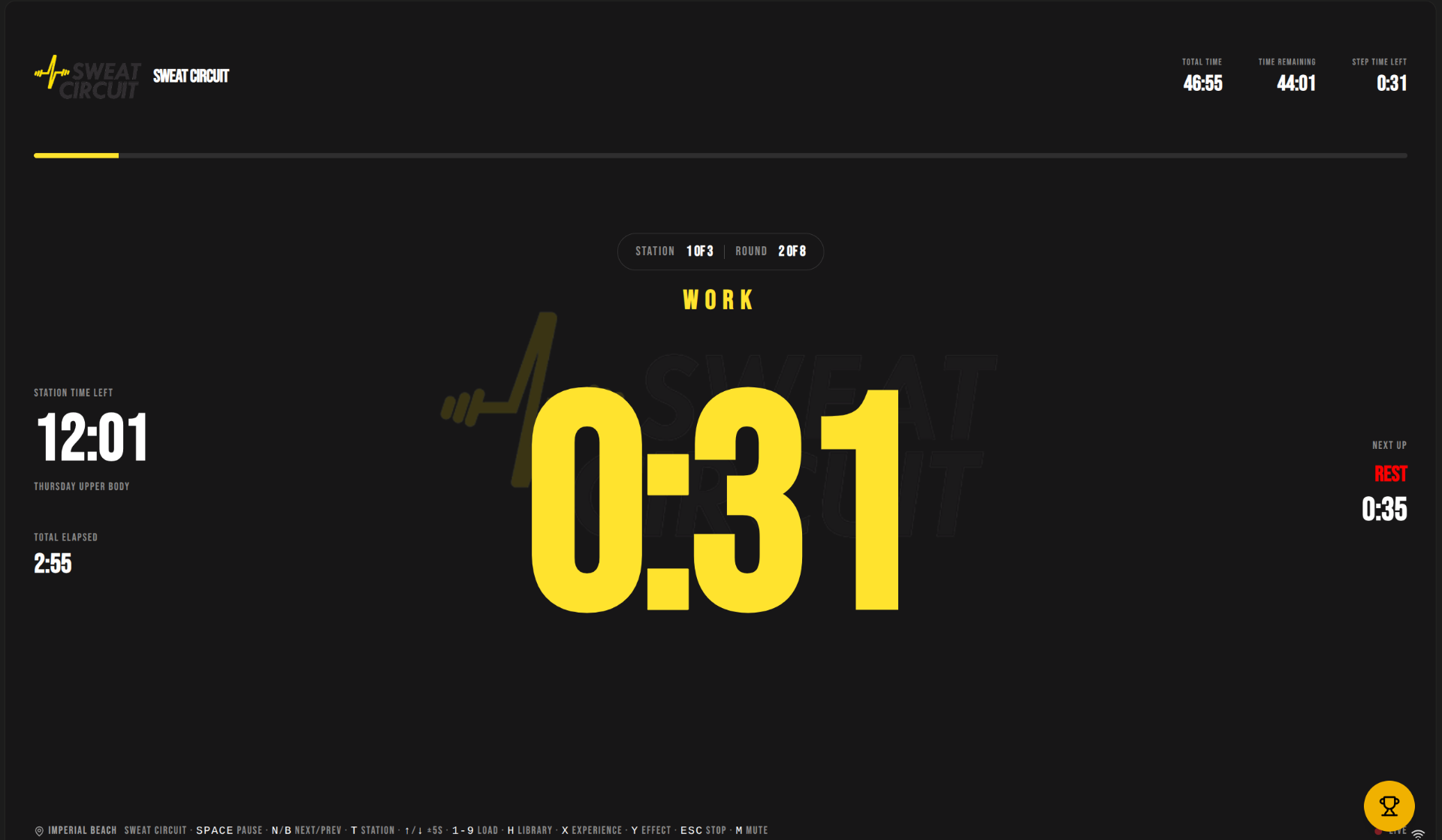 F:timer running a Sweat Circuit class on a gym TV — branded workout clock with station and round tracking